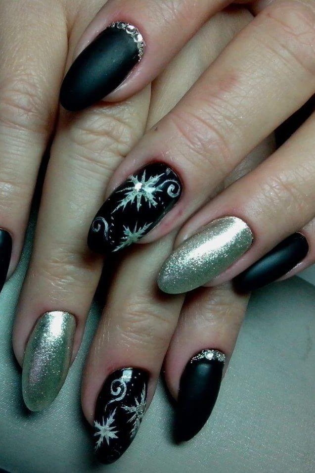 Glossy black nails with intricate silver snowflakes, striking winter manicure