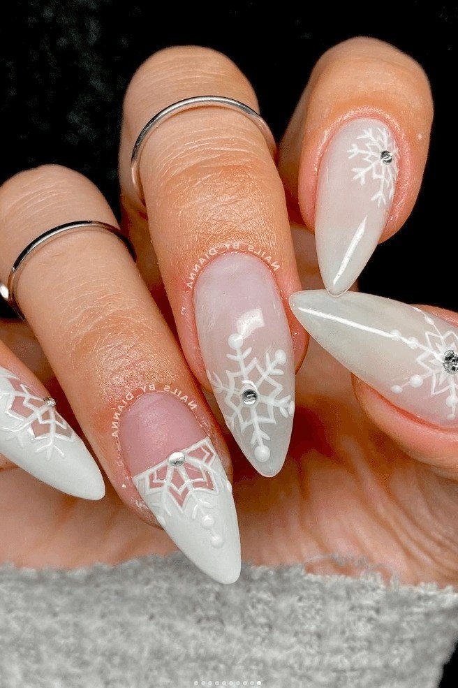 White chrome nails with delicate snowflake art, modern icy winter manicure