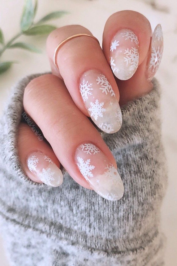 All-nude nail set with tiny white snowflakes, quiet polished winter elegance
