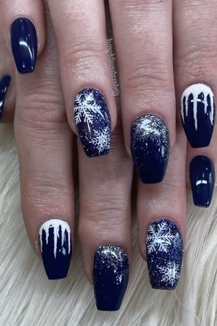 Navy nails with icicle drips and tiny snowflakes, frosty winter wonderland nail art