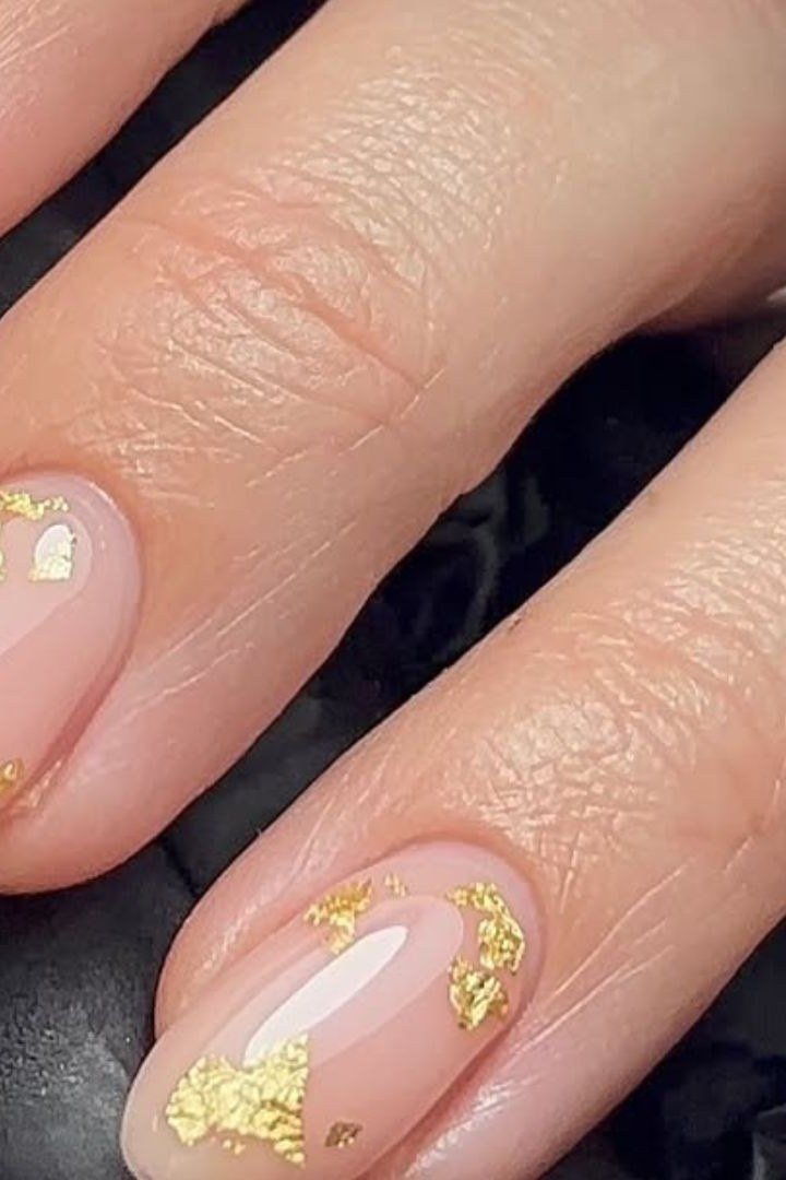 Gold leaf accents on sheer nude nails