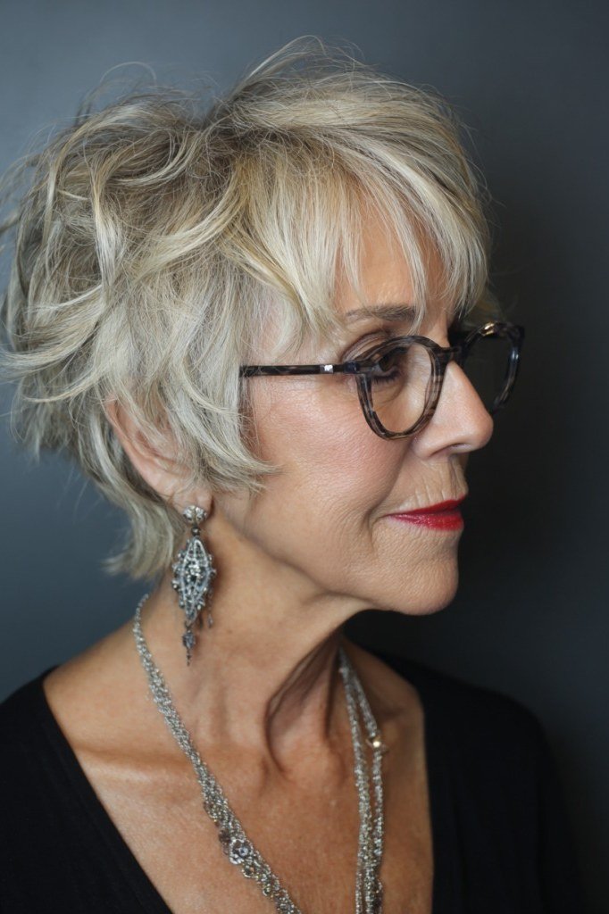 Curly blonde spiky pixie cut for women over 60 with glasses