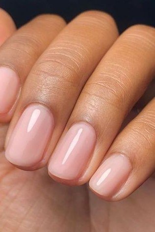 Soft Pink Almonds on Deeper Skin - simple pink nail idea for women over 50