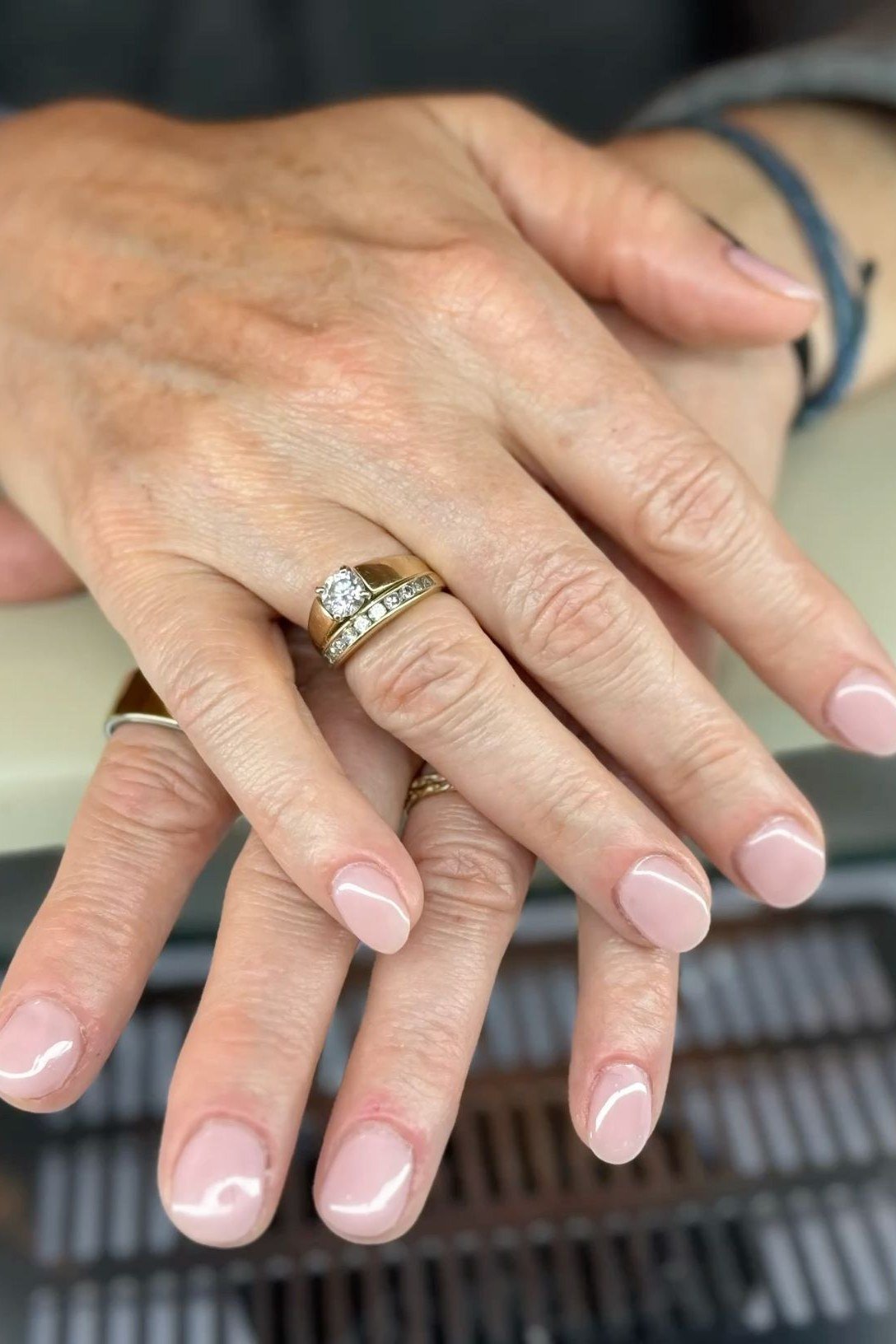 Sheer Nude Pink With a Gold Ring - simple pink nail idea for women over 50
