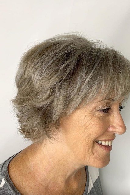 Short gray textured pixie bob for women over 60, side profile view