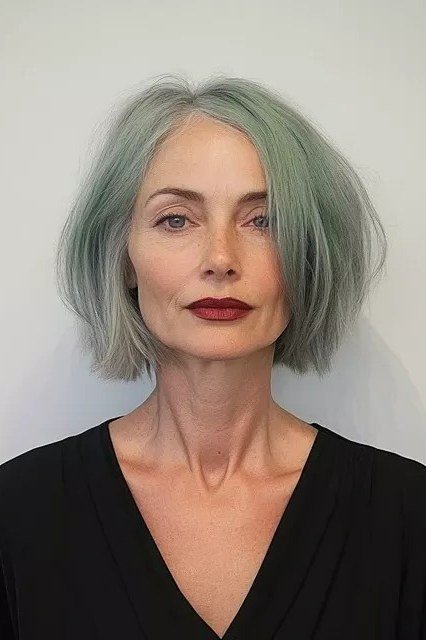 Gray green tinted bob haircut for women over 60, front view, sleek finish