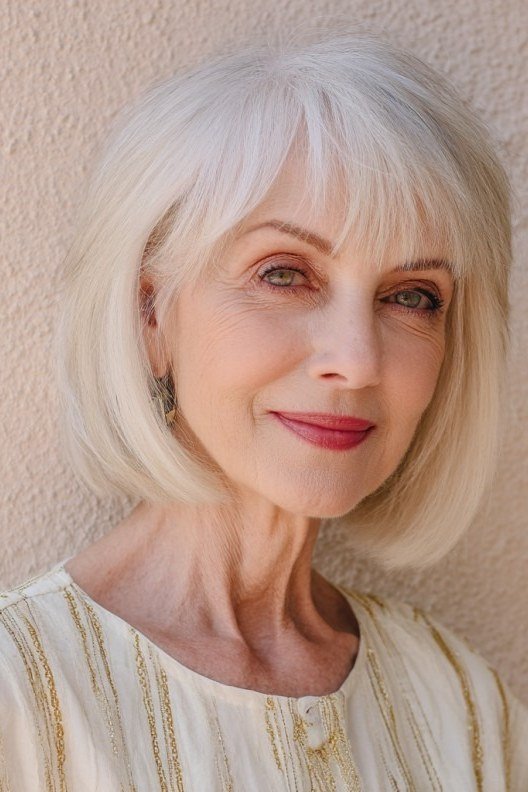 White classic bob with bangs for women over 60, front view
