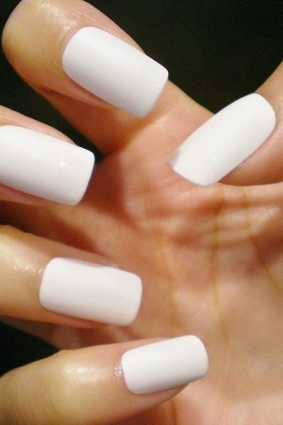 Creamy white squoval nails with glossy finish on dark background, simple summer nails