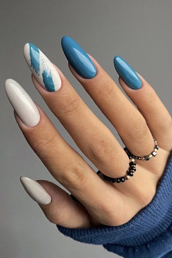 Teal and white almond nails with teal brushstroke nail art, bold summer nails