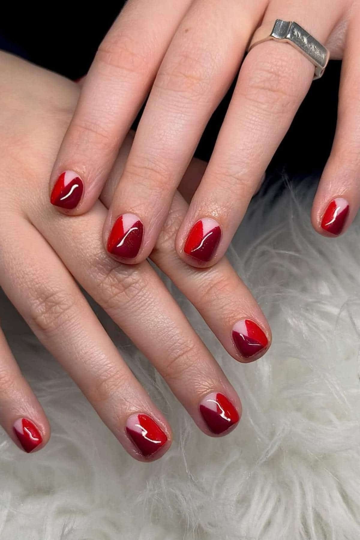 Red nails with nude half moon accents at cuticles, reverse French summer nails