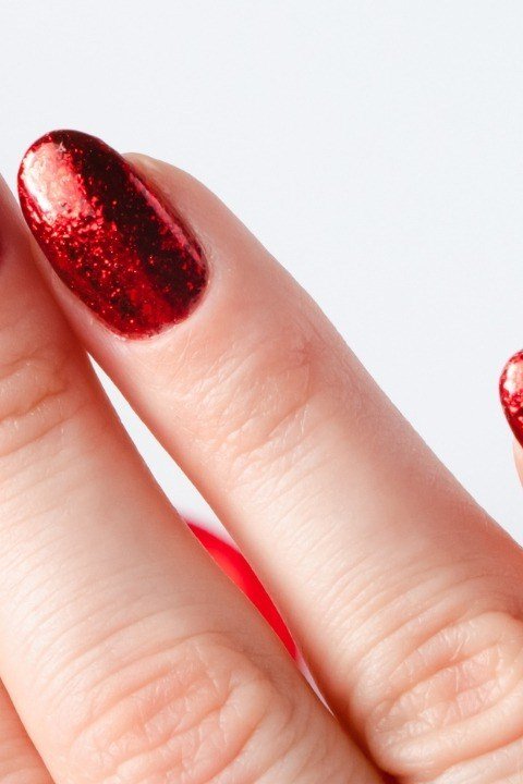 Metallic red chrome mirror nails on almond shape, bold summer red nails