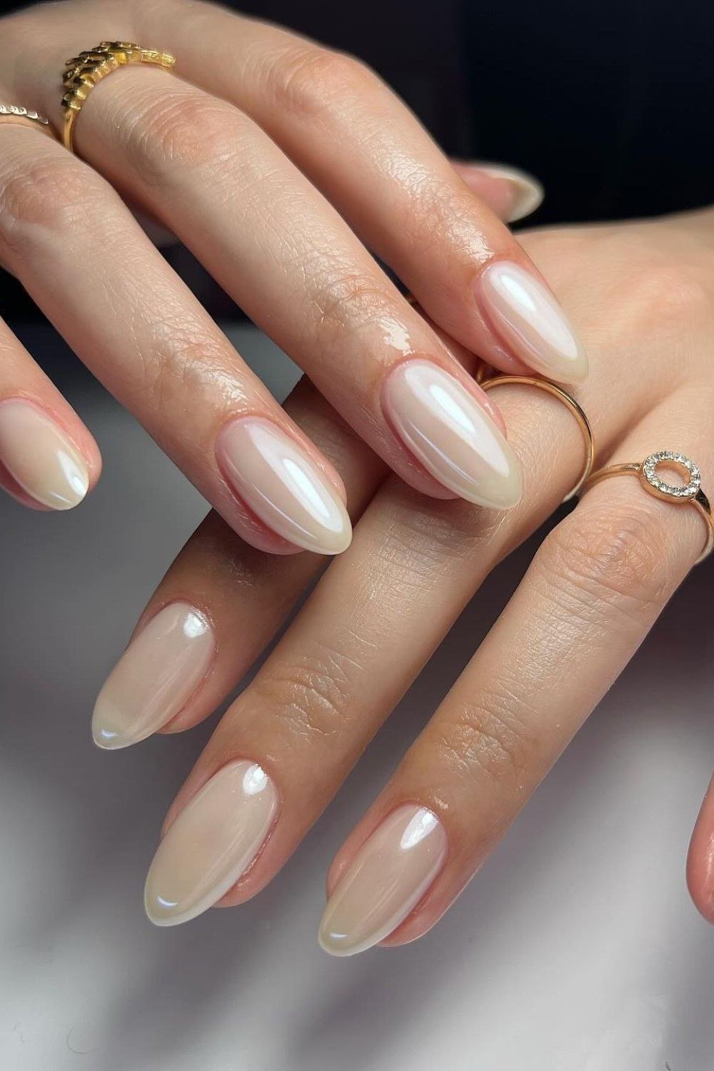 Pearly white chrome almond nails with iridescent shine, elegant summer white nails