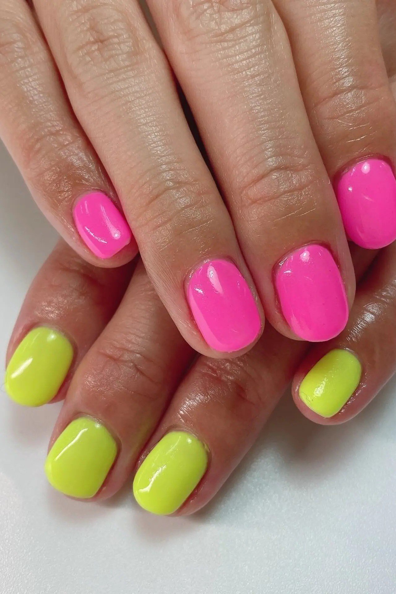 Hot pink and neon lime yellow mix nails, bold two tone summer nails for women over 40