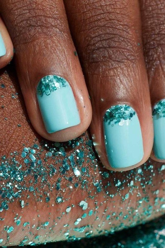 Turquoise short nails with teal glitter at cuticles on dark skin, sparkling summer nails