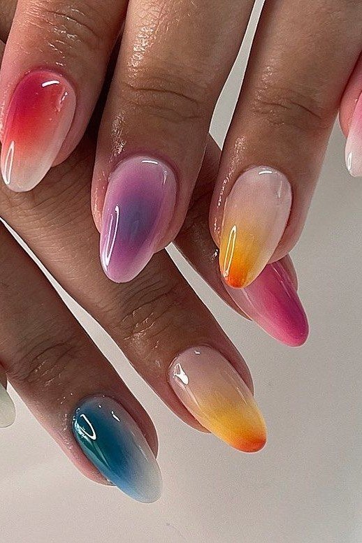 Pastel rainbow aura ombre nails with pink purple teal and yellow gradient tips