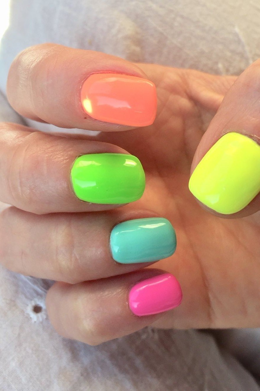 Neon rainbow mix short nails in coral green yellow teal and pink, playful summer nails