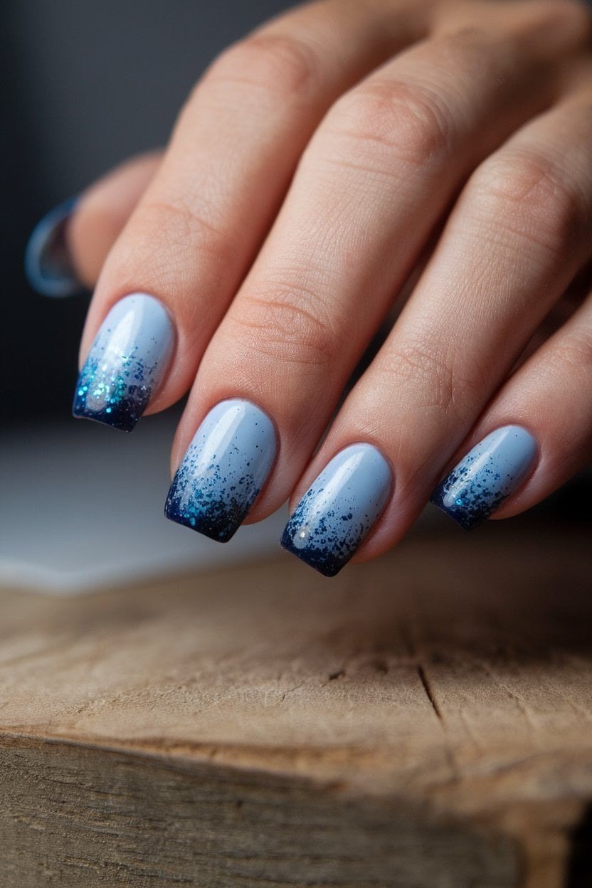 Pale blue nails fading to deep blue glitter tips, ocean ombre summer glitter nails