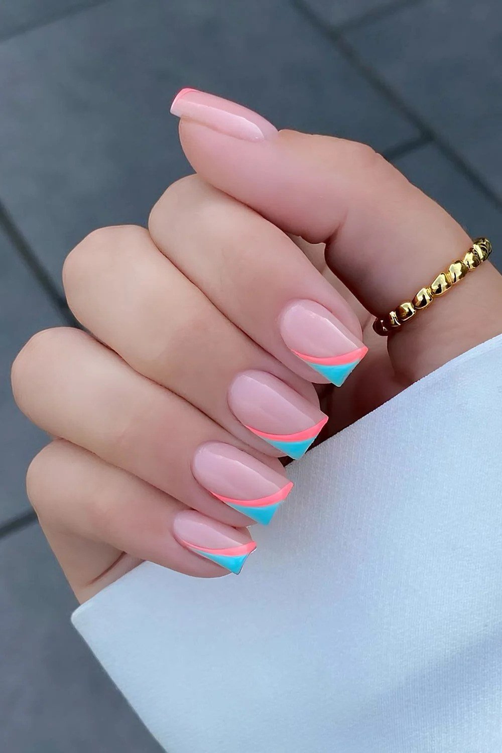 Nude almond nails with pink and turquoise double French tips, colorful summer French nails