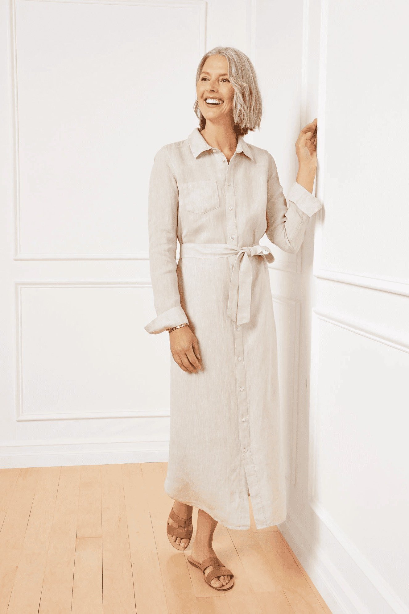 Older woman wearing white linen shirt dress - summer sundresses for women over 60