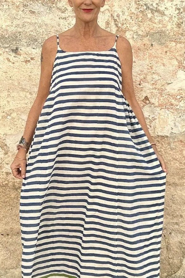 Older woman wearing navy white striped maxi sundress, no face shown - summer sundresses for women over 60