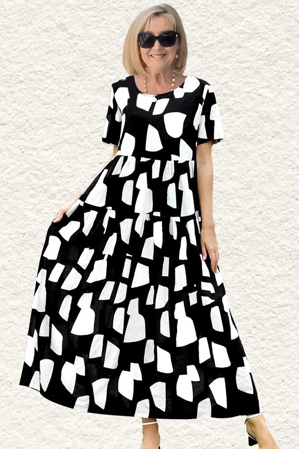 Older woman wearing black white abstract print maxi dress - summer sundresses for women over 60