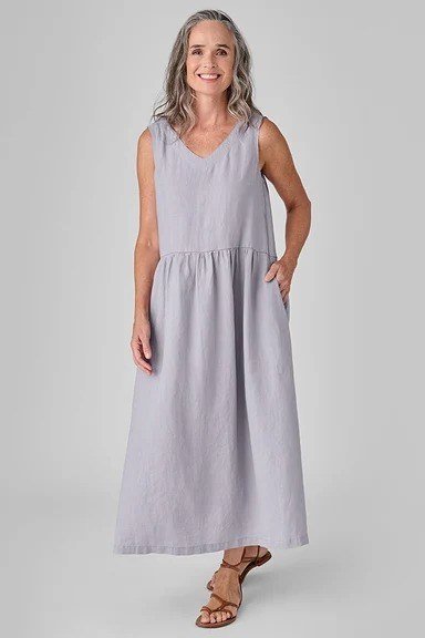 Older woman wearing lavender sleeveless maxi dress, studio - summer sundresses for women over 60