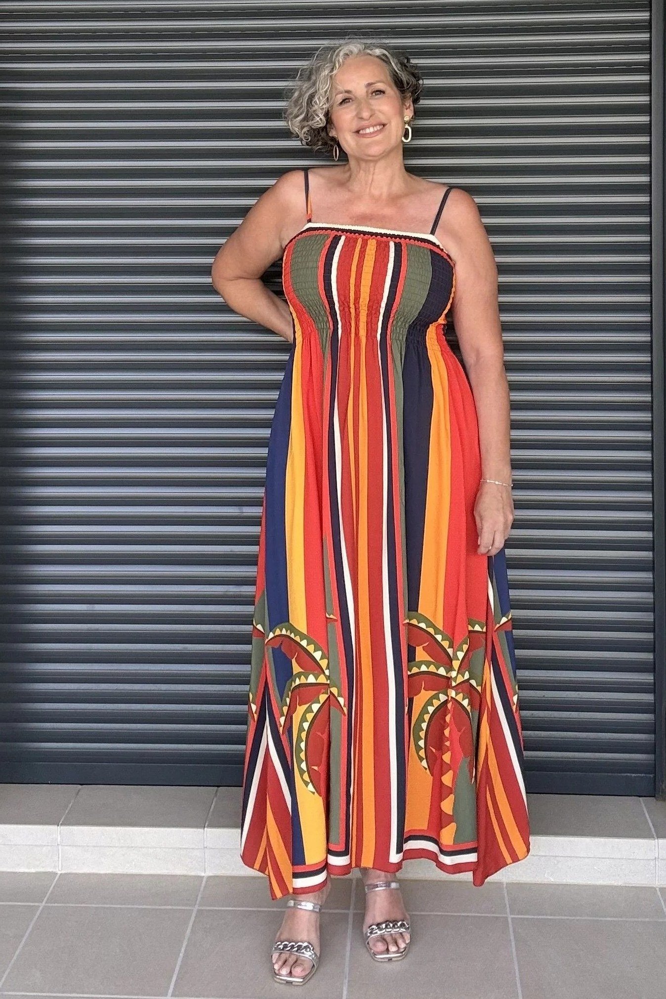 Older woman wearing rainbow striped strapless maxi dress - summer sundresses for women over 60