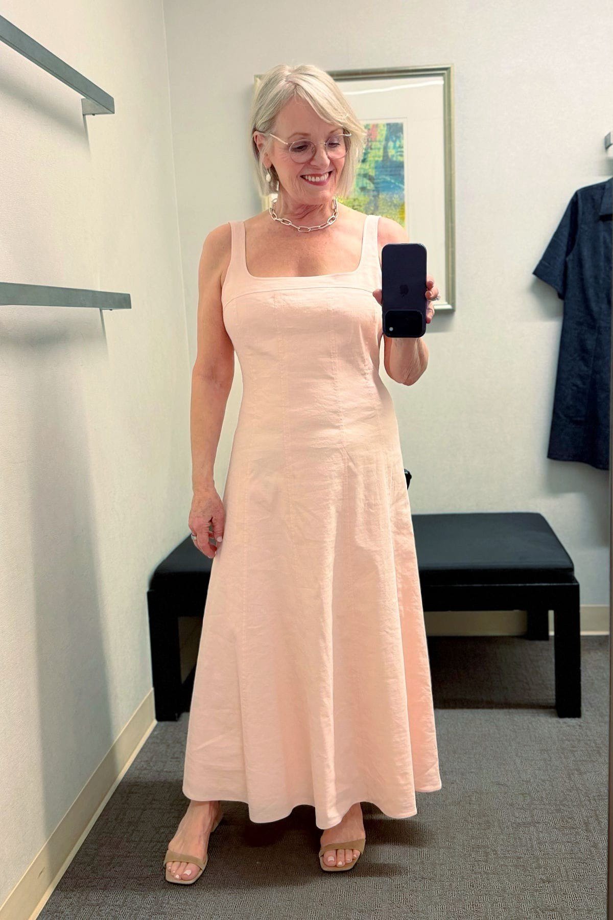 Older woman wearing peach maxi sundress, fitting room selfie - summer sundresses for women over 60