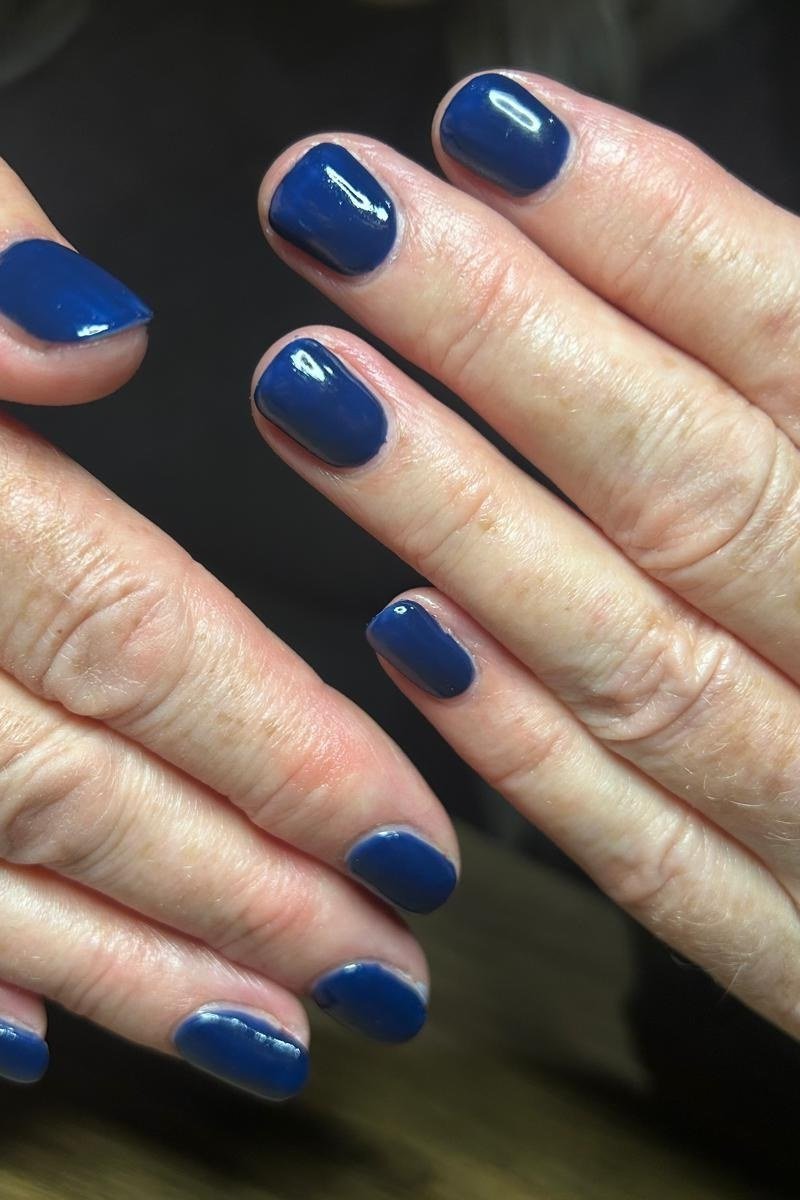Midnight navy nail polish on very aged hands