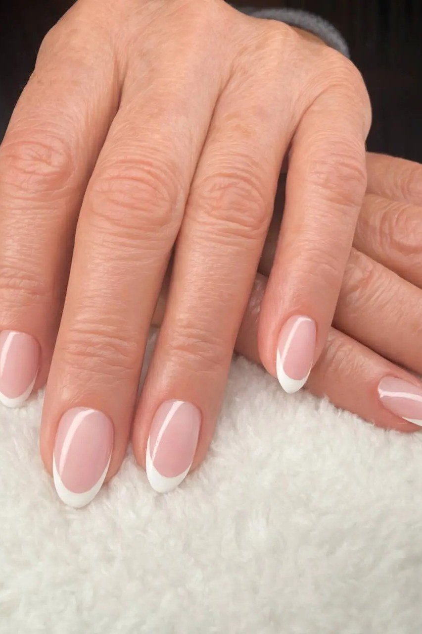 Timeless french manicure on mature older hands