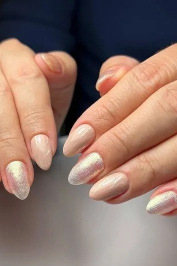 Nude to white ombre nails with gold shimmer accents