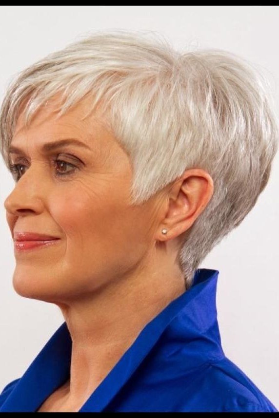 White pixie haircut for women over 60 with blue collar, three-quarter view