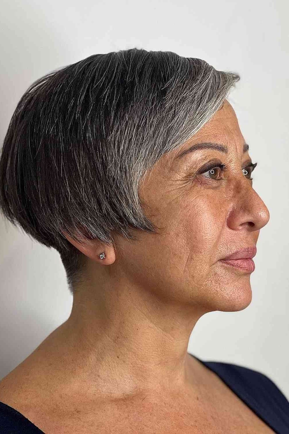 Dark gray rounded pixie bob haircut for women over 60, side view