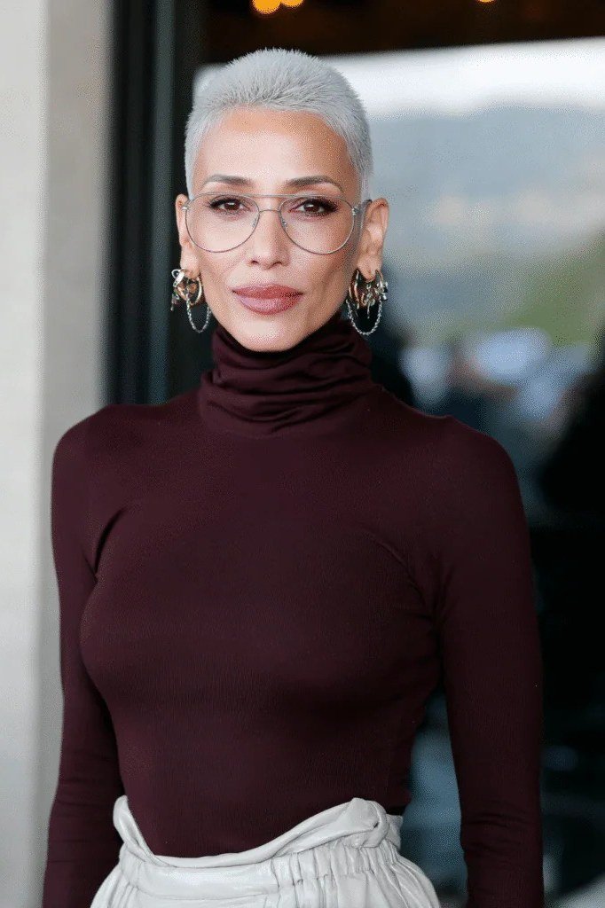 White pixie haircut for women over 60 with maroon turtleneck