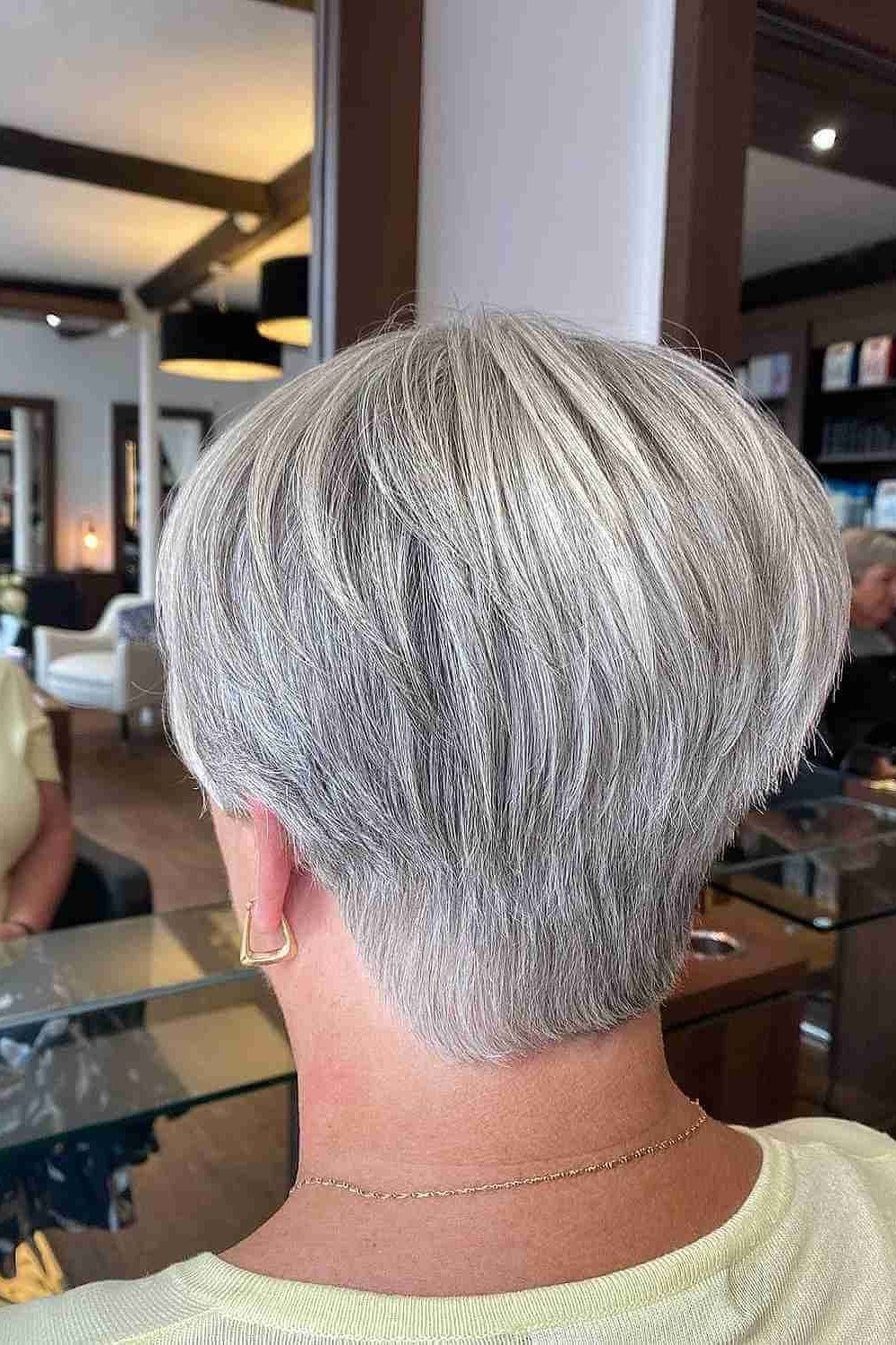 Silver pixie haircut for women over 60 with warm smile