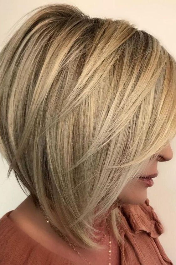 Layered bob haircut for thin fine hair over 50, side view, honey-blonde layered bob with longer face-framing front pieces