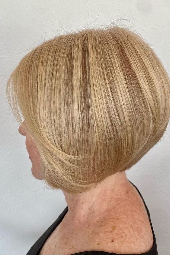 Layered bob haircut for thin fine hair over 50, side view, golden-blonde stacked layered bob