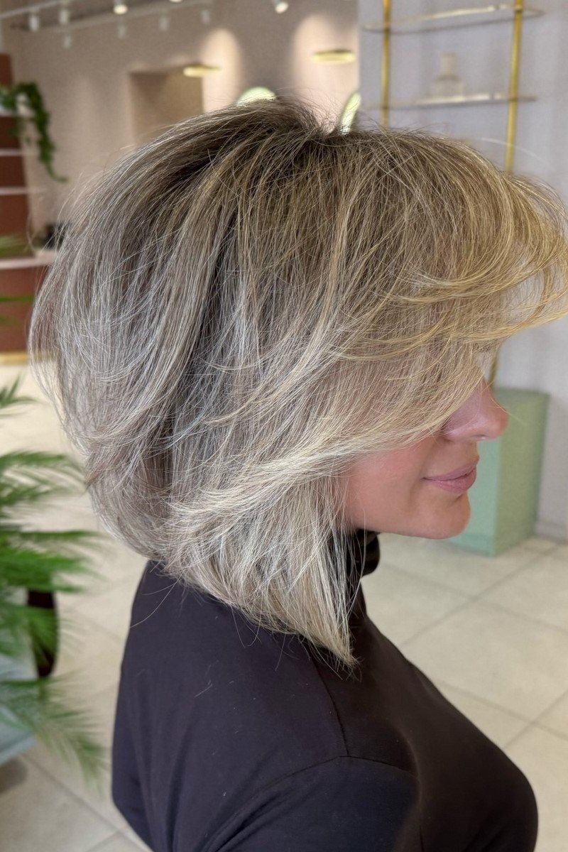 Layered bob haircut for thin fine hair over 50, side view, silver-gray layered bob with texture