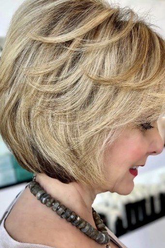 Layered bob haircut for thin fine hair over 50, side view, blonde feathered layered bob