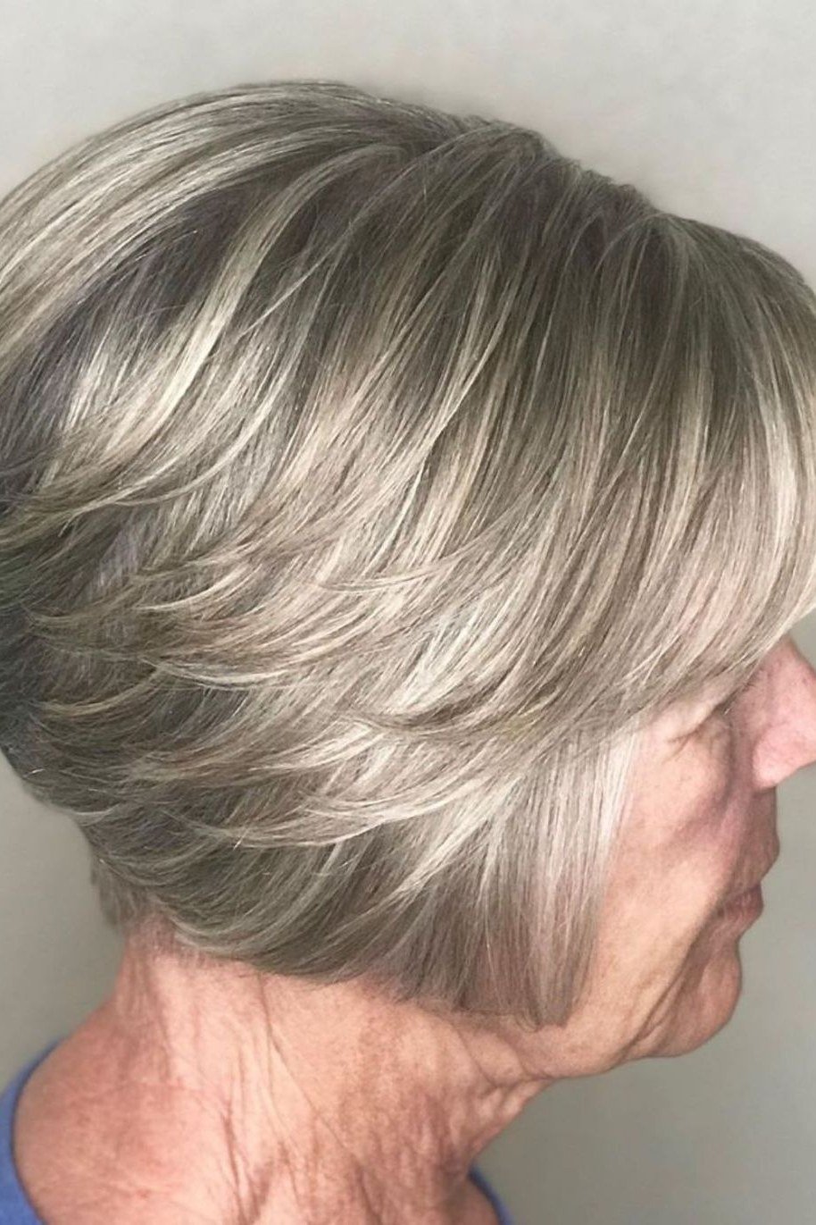 Layered bob haircut for thin fine hair over 50, side view, silver stacked bob with rounded shape