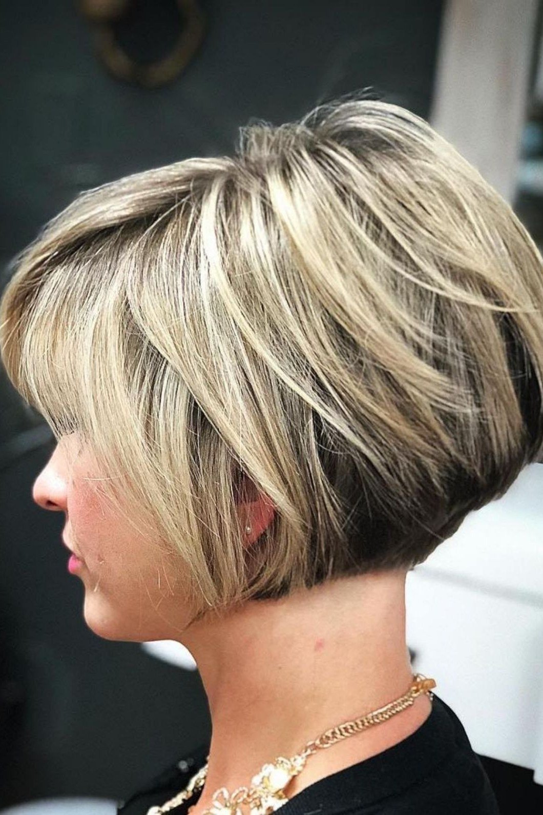 Layered bob haircut for thin fine hair over 50, side view, white-blonde stacked layered bob