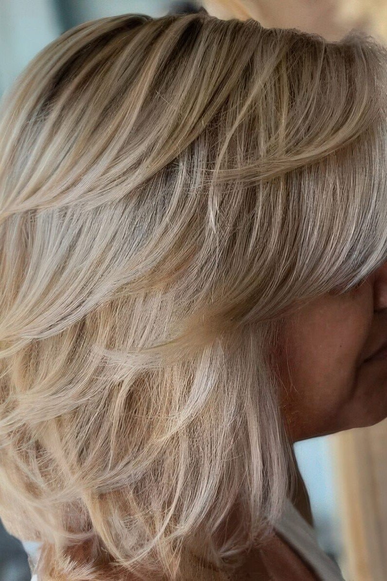 Layered bob haircut for thin fine hair over 50, side view, silver layered bob with volume