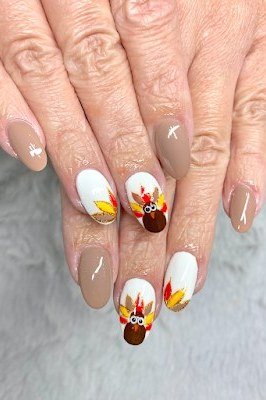 Cute turkey face nail art on white and taupe nails, Thanksgiving nails for women over 60