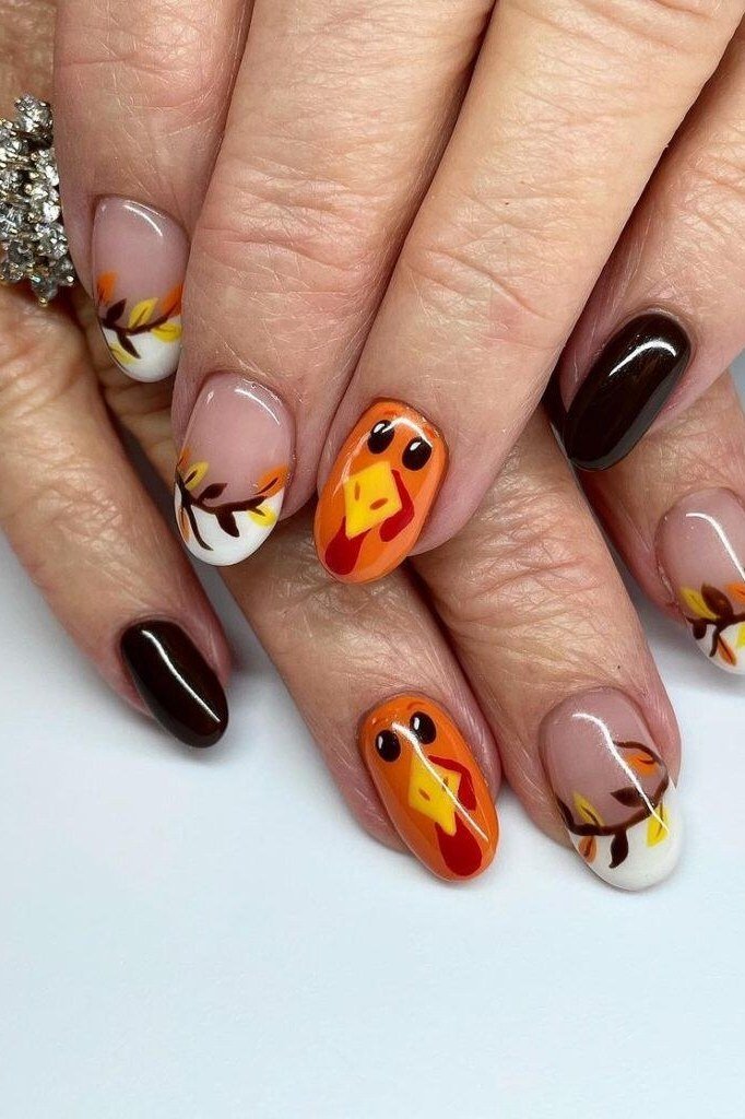 Cartoon turkey nail art on orange and black almond nails