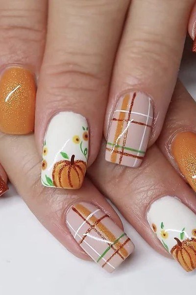 White plaid nail art with pumpkin and burnt orange glitter