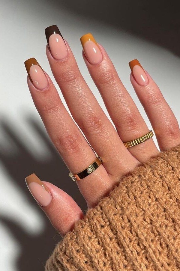 Nude French manicure with brown tips on coffin nails