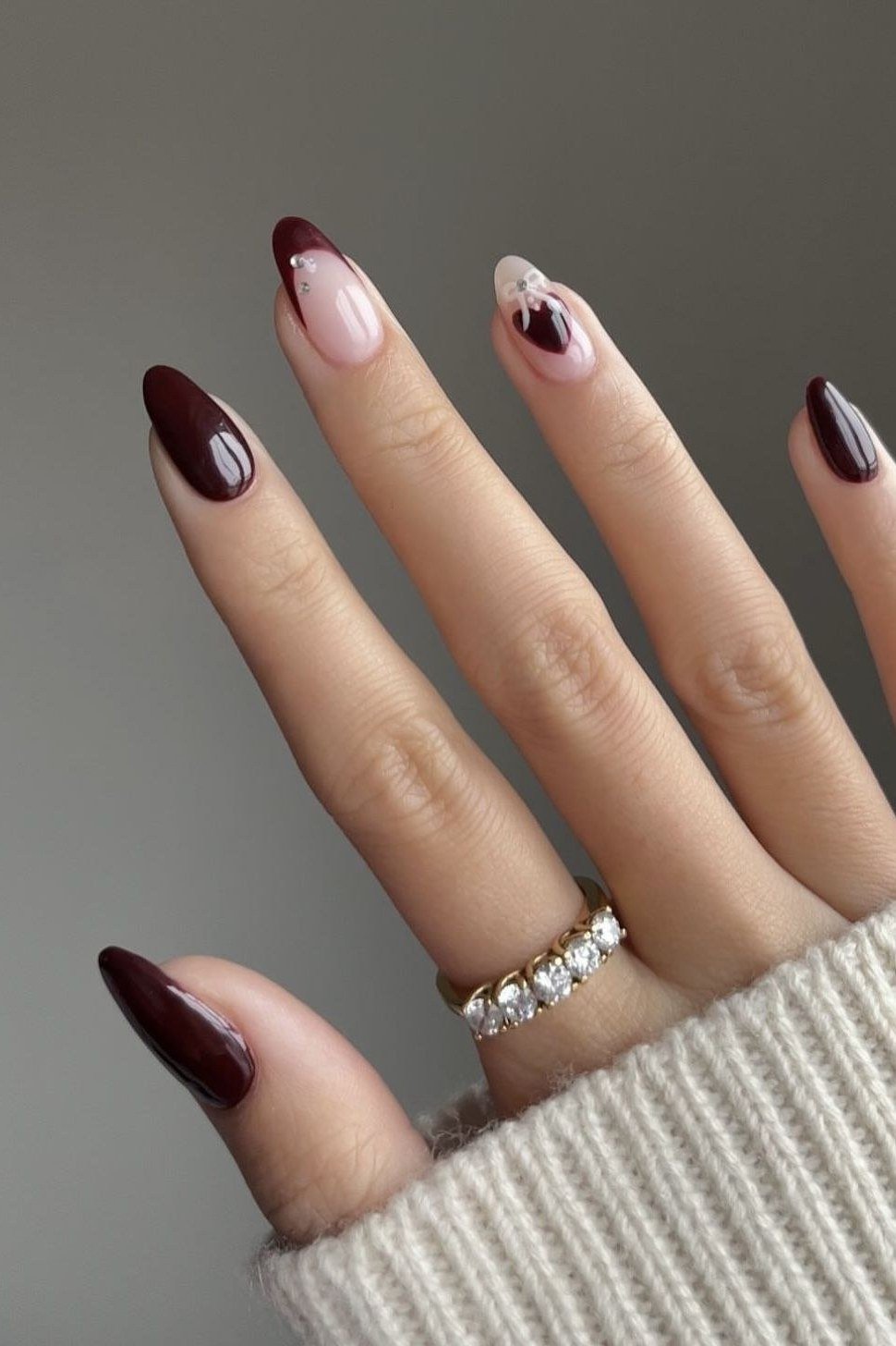 Deep burgundy almond nails with glossy finish