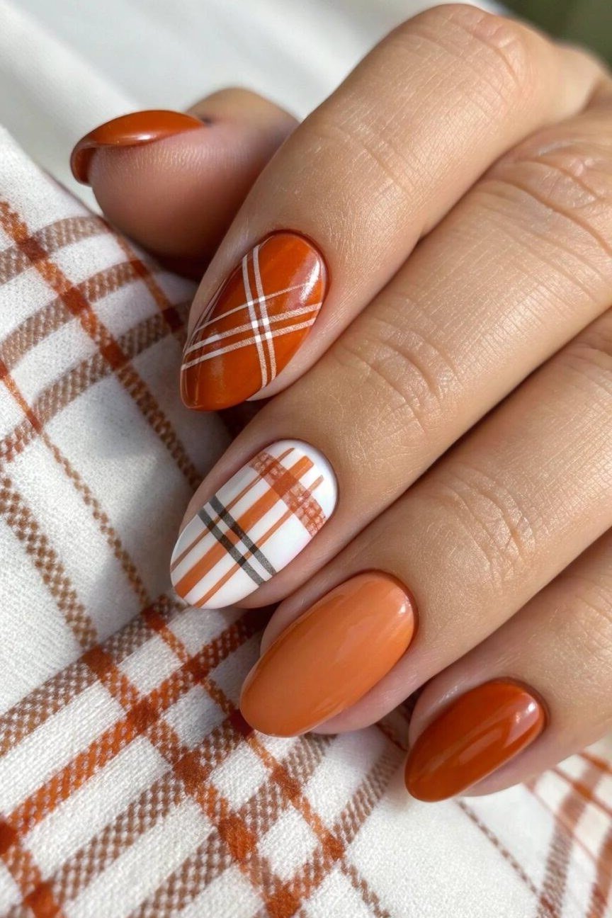 Orange plaid nail art on almond nails