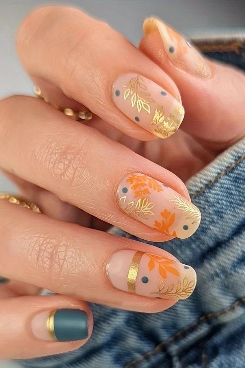 Clear nails with embedded fall leaves nail art
