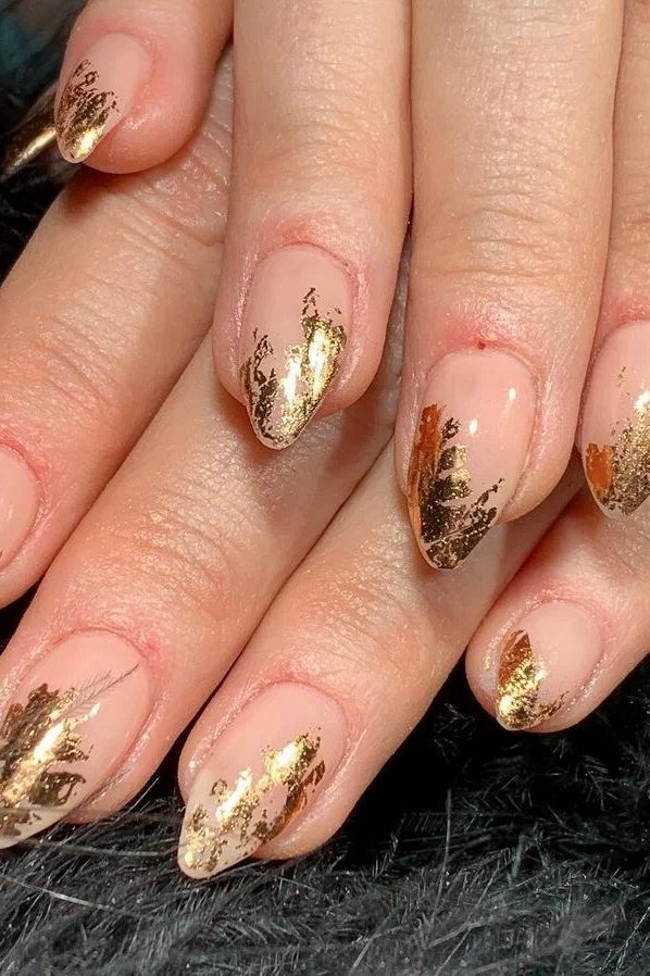 Nude almond nails with gold foil tips